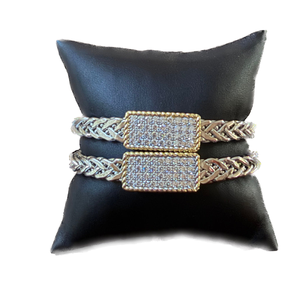 Two Braided Cable Wire  Bracelets with Rectangular pavé Accent Bar on a black satin pillow.