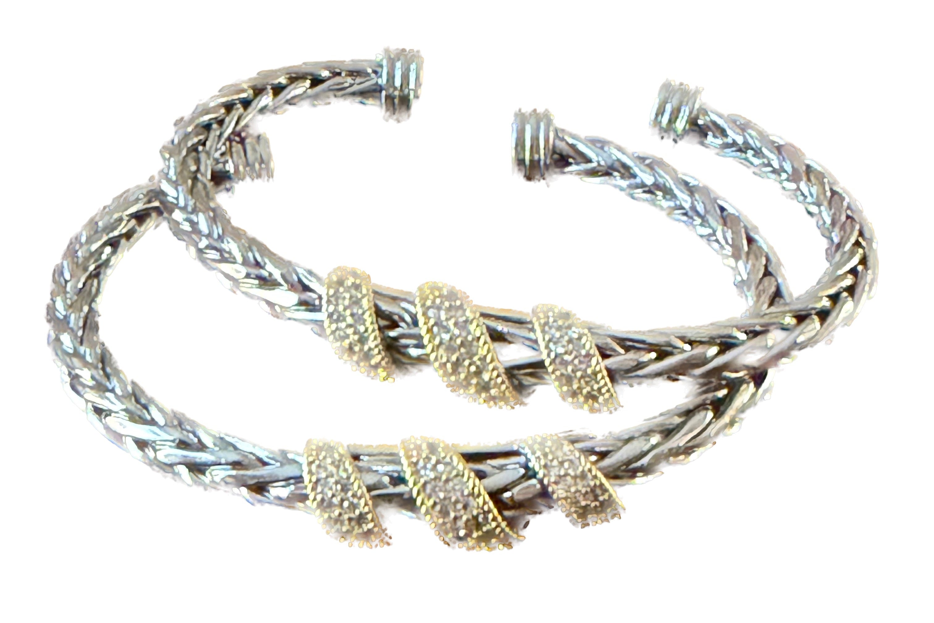 Stack of braided bracelets with gold and silver accents on a white background