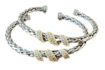 Load image into Gallery viewer, Stack of braided bracelets with gold and silver accents on a white background
