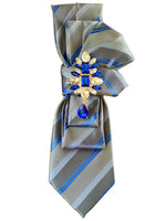 Load image into Gallery viewer, Gray and blue striped tie with decorative brooch on a white surface

