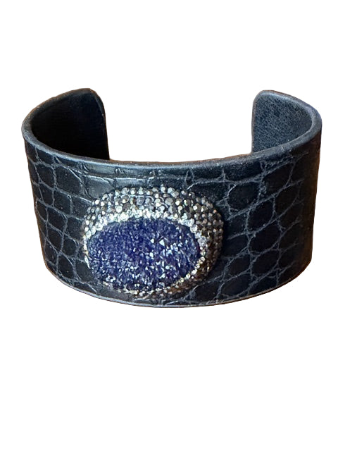 Black crocodile-patterned cuff bracelet with a blue gemstone and silver accents 