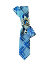 Load image into Gallery viewer, Blue plaid tie with decorative clasp on a white surface
