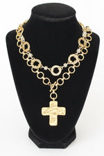 Load image into Gallery viewer, A gold-toned chain necklace with a hammered cross pendant, displayed on a black velvet jewelry bust against a white
 background.
