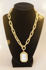 Load image into Gallery viewer, Matte Gold Chain Link Necklace with MOP pendant on a black velvet stand
