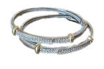 Load image into Gallery viewer, Set of silver bangles with gold accents on a white background
