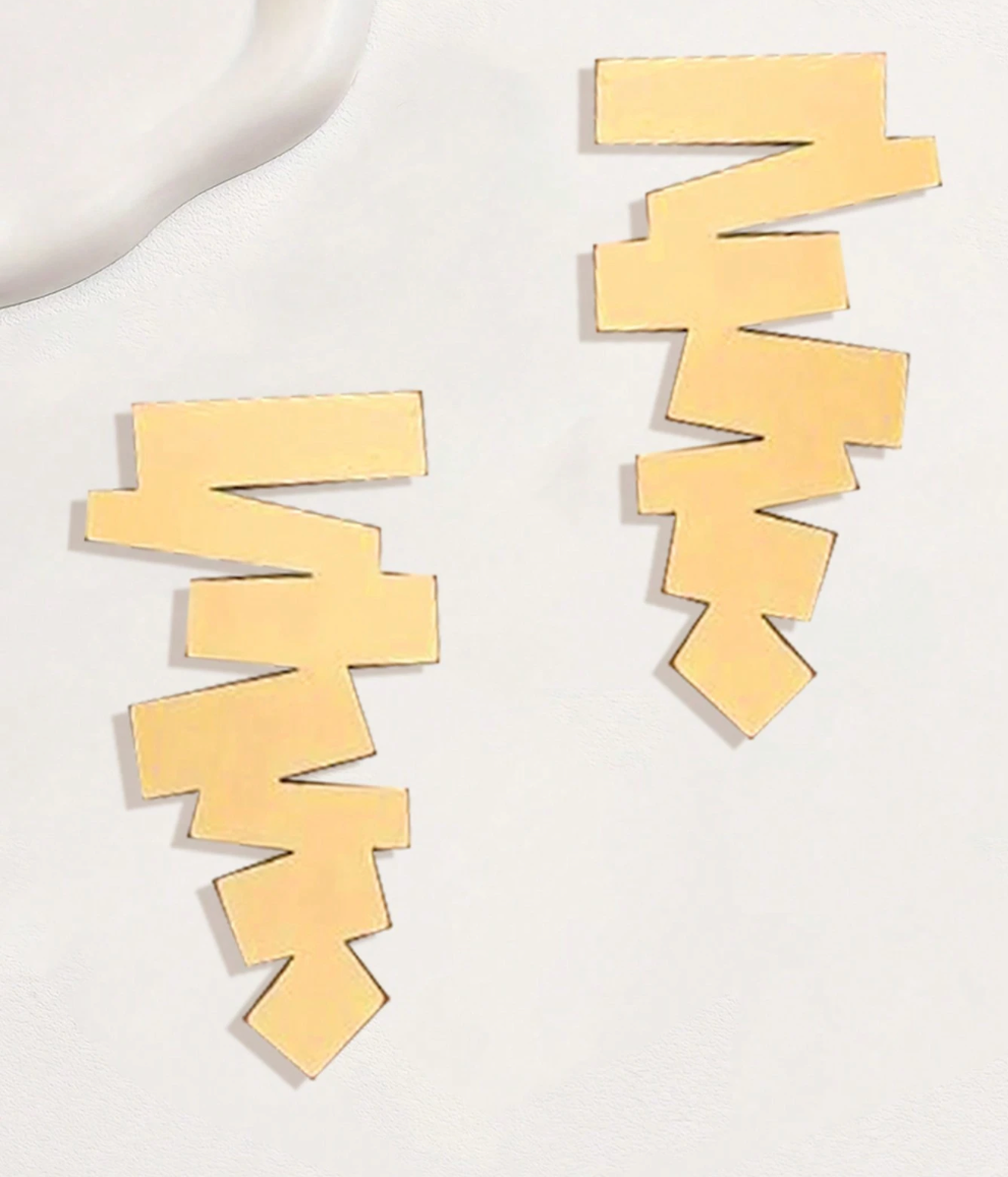Gold geometric earrings on a white background