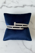 Load image into Gallery viewer, Silver Pavé nail bracelet on a blue satin pillow with white background
