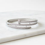 Load image into Gallery viewer, Silver bracelet with clear stones on a white surface

