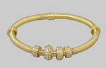 Load image into Gallery viewer, Gold bracelet with decorative beads on a gray background
