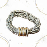 Load image into Gallery viewer, A multi-strand silver chain bracelet with a textured gold-toned wrap closure, displayed on a white background
