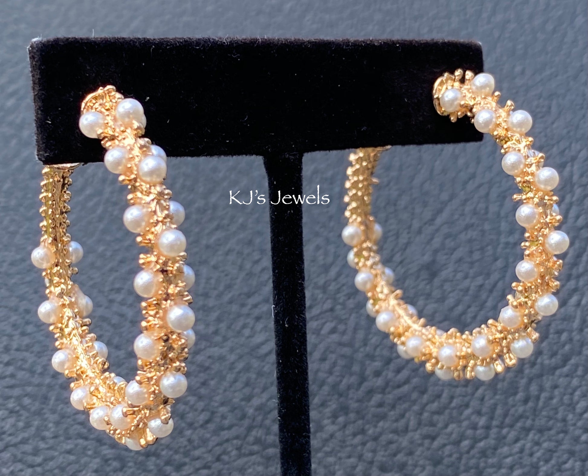 beautiful gold and pearl hoop earrings, 1.5 inches, pierced, on black earring display
